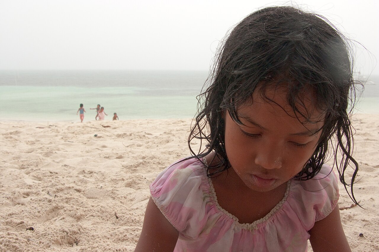 A rain-soaked Filipina girl on Malapascua Island, Philippines