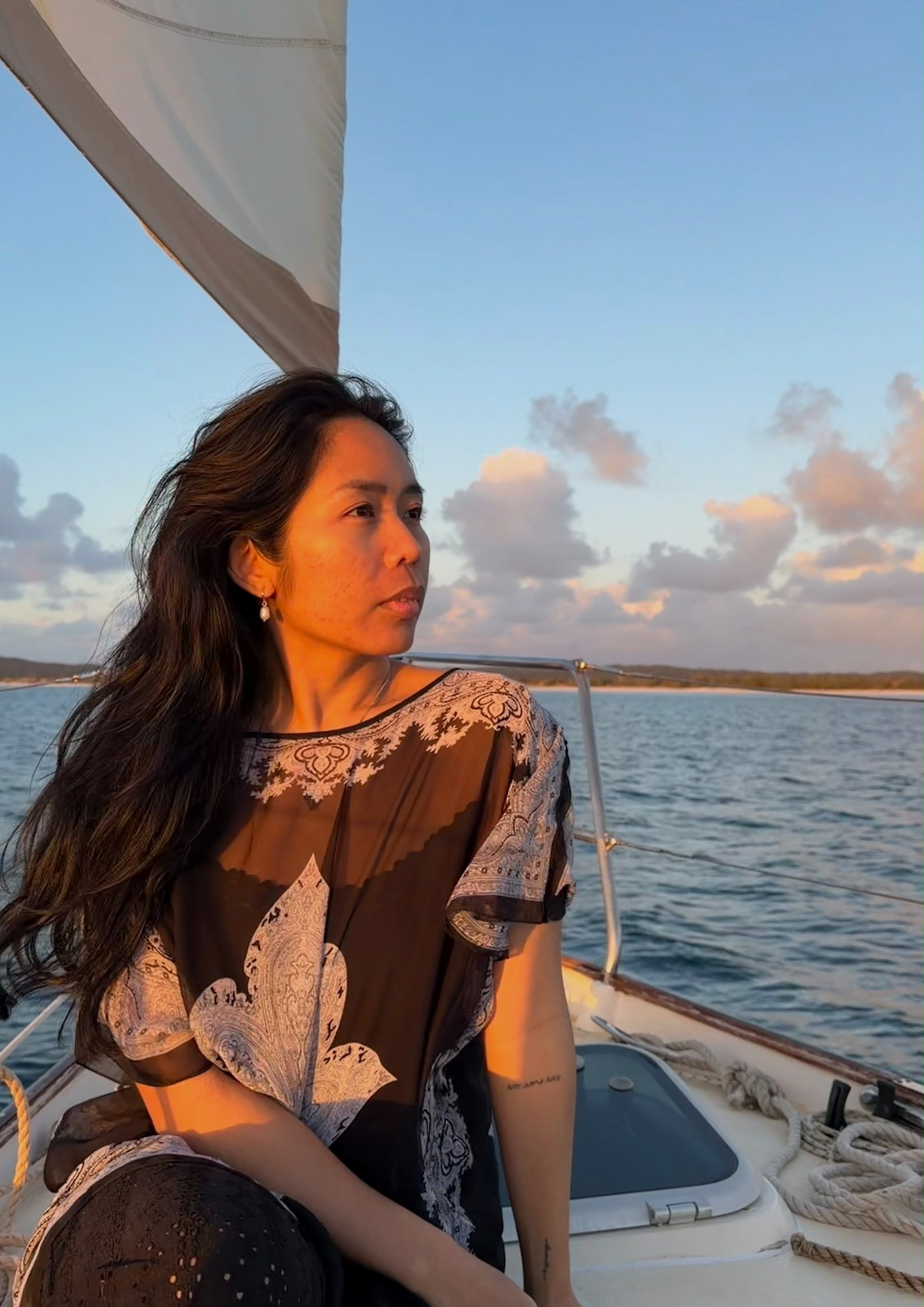 Sarah Suyom sailing at sunset